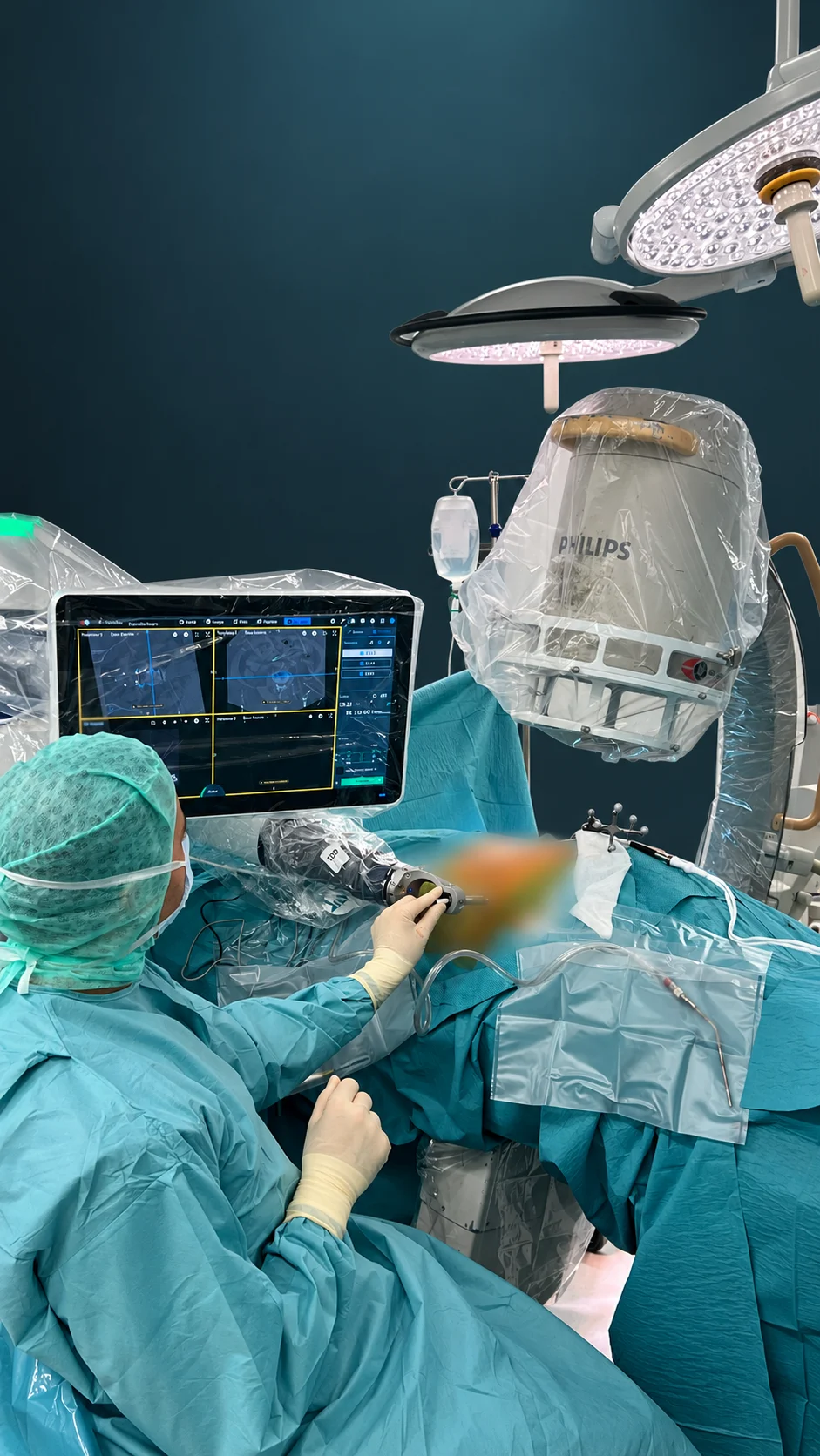 Surgeon using robotic navigation equipment in the supplied operating-room scene, with the patient's operative area blurred